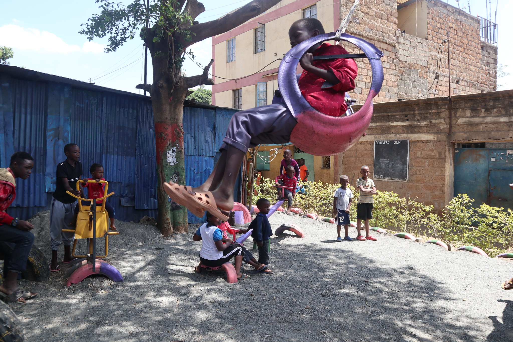 A boy plays on a swing in a children’s playground created by local youth in a former crime ridden area on the outskirts of the Kenyan capital Nairobi UN-Habitat2019Susannah Price