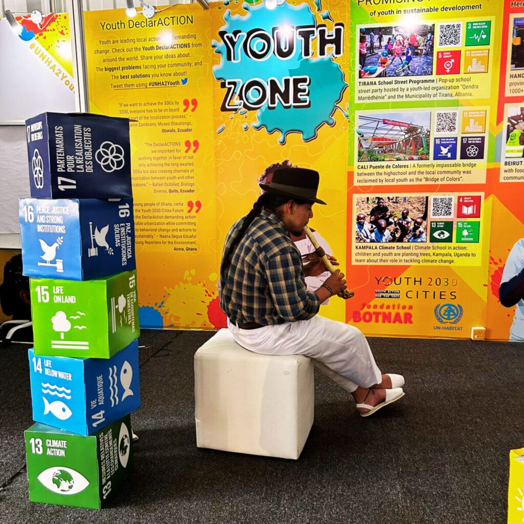 Lenin Zambrano playing flute at Youth Zone at 2023 UN-Habitat Assembly